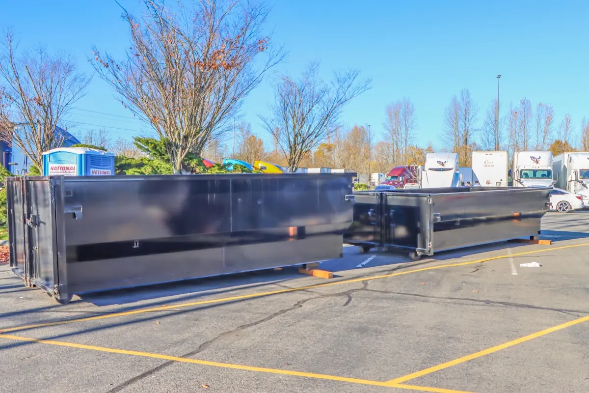 Professional dumpster rental service with roll-off container on residential driveway in Leesville